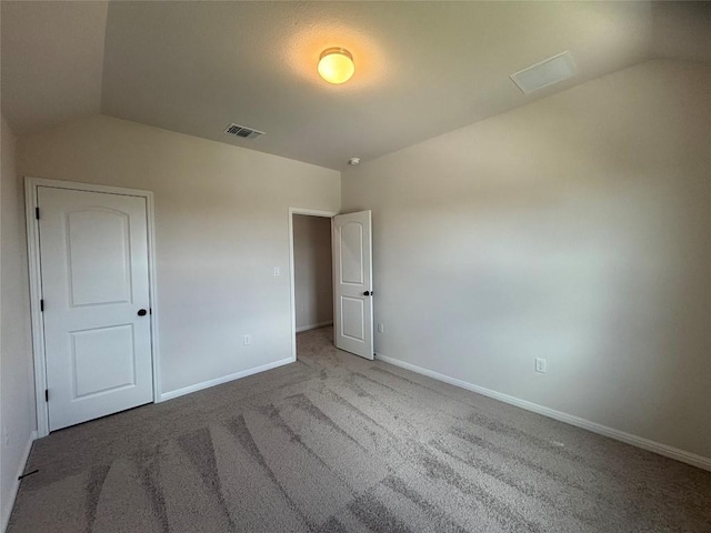 627 Palo Brea Loop, Hutto, TX 78634 - unfurnished bedroom with vaulted ceiling and carpet flooring