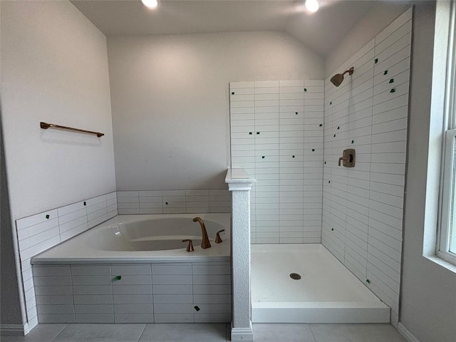 627 Palo Brea Loop, Hutto, TX 78634 - full bath with tile patterned flooring, a garden tub, a tile shower, and lofted ceiling