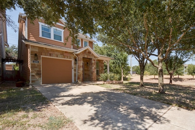 1209 Salem Park Ct, Austin, TX 78745 - view of front of house featuring stone siding, an attached garage, and concrete driveway