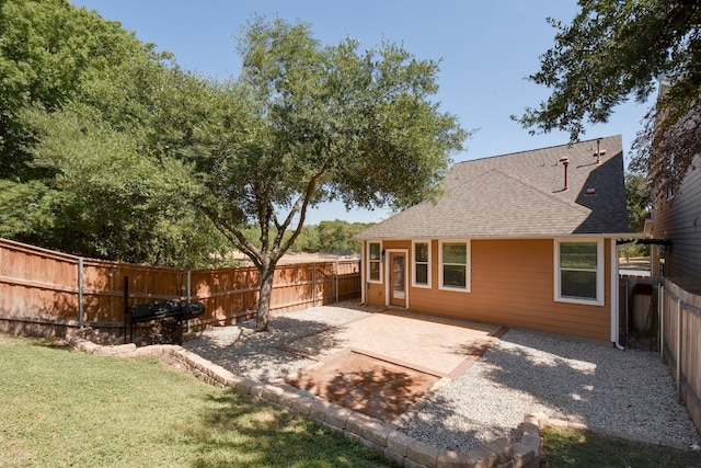 1209 Salem Park Ct, Austin, TX 78745 - rear view of house featuring roof with shingles, a patio, and a fenced backyard