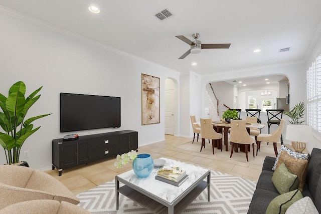1209 Salem Park Ct, Austin, TX 78745 - living area with arched walkways, light tile patterned flooring, recessed lighting, a ceiling fan, and crown molding