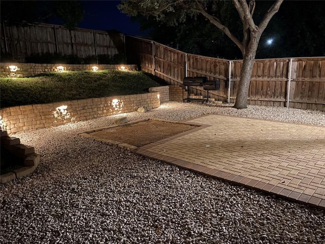 1209 Salem Park Ct, Austin, TX 78745 - patio at night featuring a fenced backyard and a patio