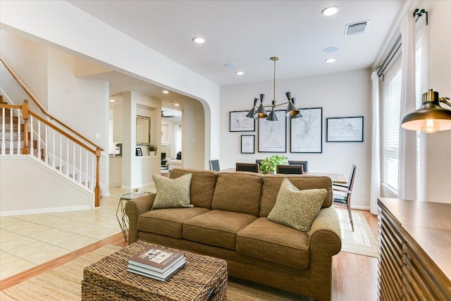 13412 Snow Fall Dr, Austin, TX 78727 - living room with stairway, arched walkways, plenty of natural light, recessed lighting, and a chandelier