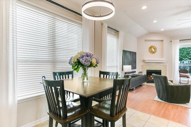 13412 Snow Fall Dr, Austin, TX 78727 - dining area featuring light tile patterned floors, a tile fireplace, vaulted ceiling, and recessed lighting