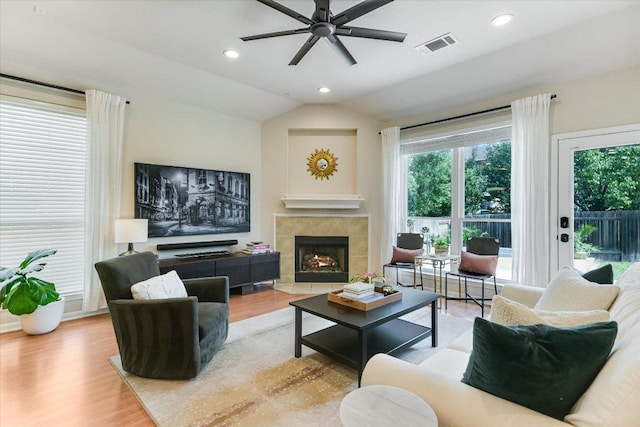 13412 Snow Fall Dr, Austin, TX 78727 - living room featuring ceiling fan, wood finished floors, a tile fireplace, vaulted ceiling, and recessed lighting