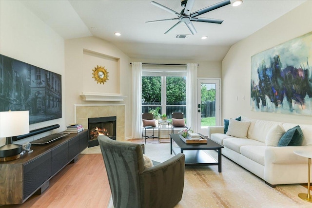 13412 Snow Fall Dr, Austin, TX 78727 - living area with vaulted ceiling, a ceiling fan, a tile fireplace, light wood-type flooring, and recessed lighting