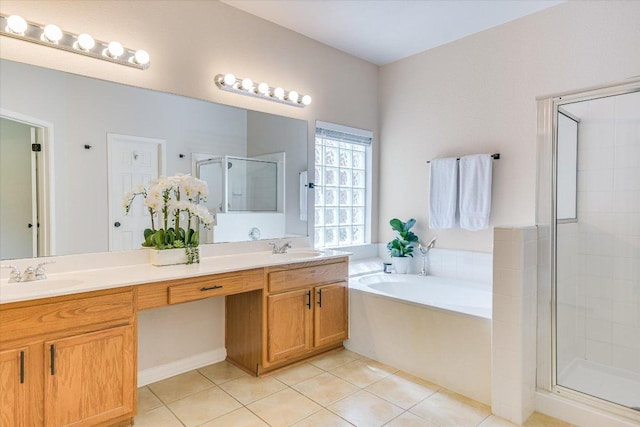 13412 Snow Fall Dr, Austin, TX 78727 - bathroom with double vanity, a stall shower, tile patterned floors, and a garden tub