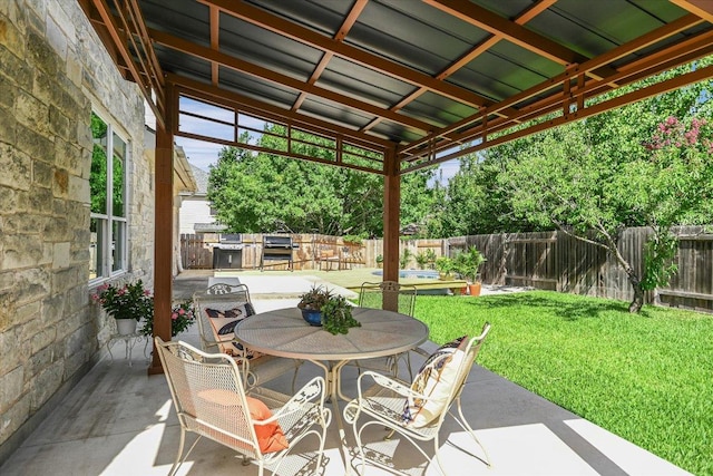 13412 Snow Fall Dr, Austin, TX 78727 - fenced backyard with a patio, outdoor dining area, and exterior kitchen