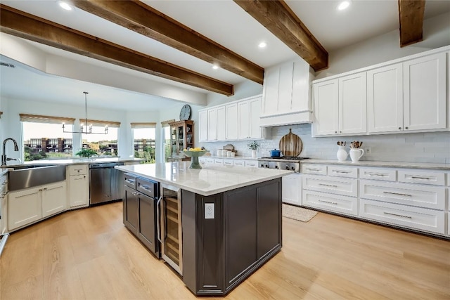 1307 Osprey Ridge Loop, Lago Vista, TX 78645 - kitchen with appliances with stainless steel finishes, wine cooler, light wood finished floors, white cabinets, and beamed ceiling
