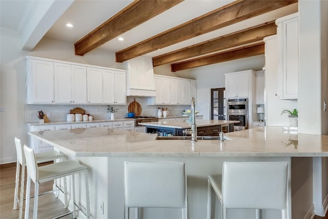 1307 Osprey Ridge Loop, Lago Vista, TX 78645 - kitchen with appliances with stainless steel finishes, beamed ceiling, white cabinets, decorative backsplash, and recessed lighting