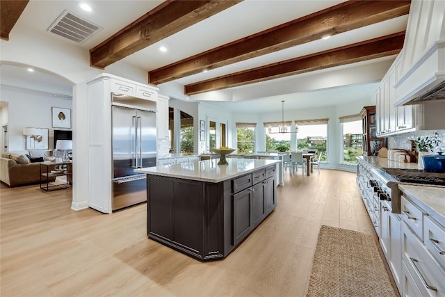 1307 Osprey Ridge Loop, Lago Vista, TX 78645 - kitchen with stainless steel appliances, custom exhaust hood, light wood-type flooring, beamed ceiling, and a kitchen island
