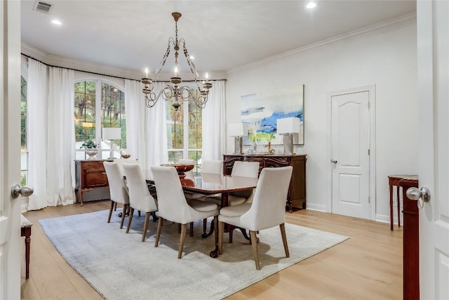 1307 Osprey Ridge Loop, Lago Vista, TX 78645 - dining space with a chandelier, light wood-style floors, and crown molding