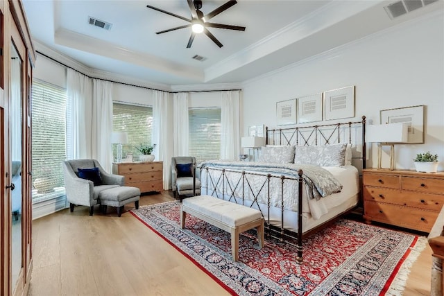 1307 Osprey Ridge Loop, Lago Vista, TX 78645 - bedroom featuring a raised ceiling, wood finished floors, ornamental molding, and a ceiling fan