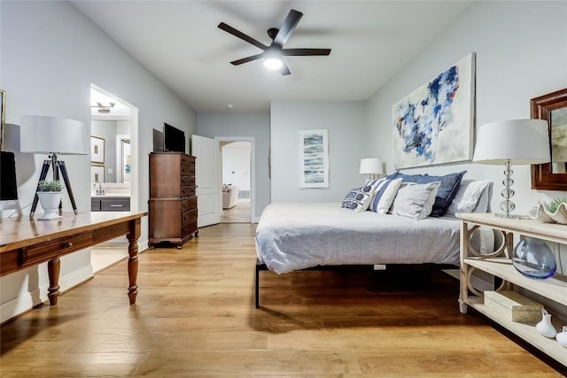 1307 Osprey Ridge Loop, Lago Vista, TX 78645 - bedroom with light wood-type flooring, connected bathroom, and ceiling fan