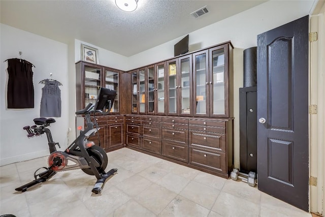 1307 Osprey Ridge Loop, Lago Vista, TX 78645 - exercise area with a textured ceiling and light tile patterned floors