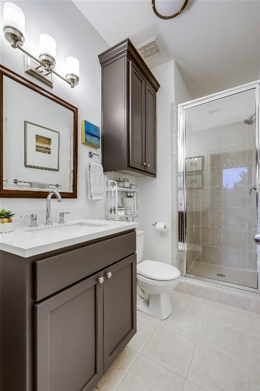 1307 Osprey Ridge Loop, Lago Vista, TX 78645 - bathroom with vanity, a shower stall, and tile patterned floors