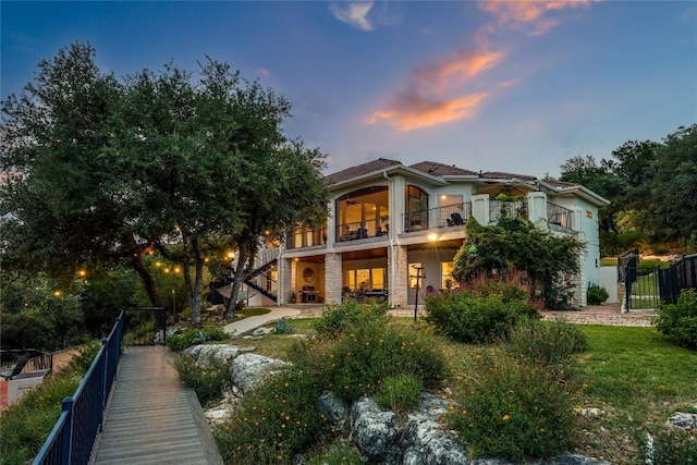 1307 Osprey Ridge Loop, Lago Vista, TX 78645 - back of house featuring a balcony, stairway, and stucco siding