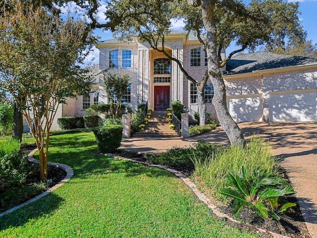 1624 Cabinwood Cv, Austin, TX 78746 - view of front facade with driveway, a front yard, a garage, french doors, and brick siding
