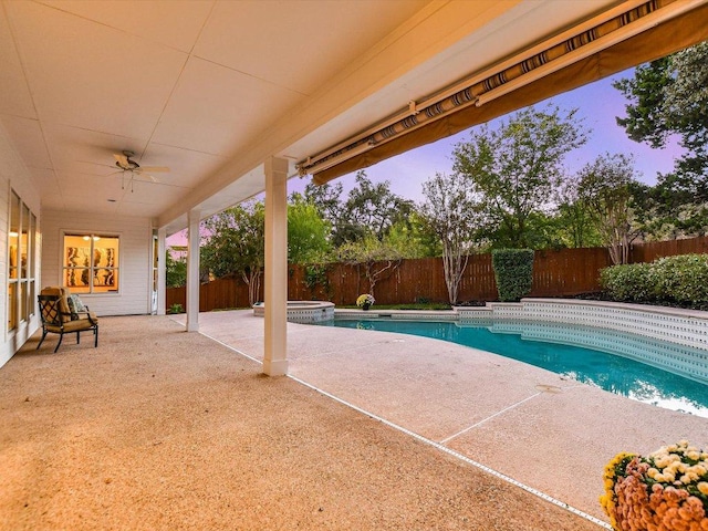 1624 Cabinwood Cv, Austin, TX 78746 - pool at dusk with a fenced backyard, a patio, ceiling fan, and a pool with connected hot tub