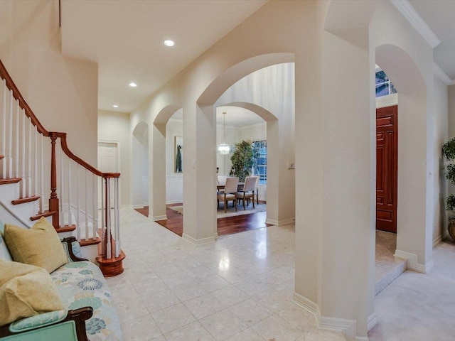 1624 Cabinwood Cv, Austin, TX 78746 - foyer entrance with arched walkways, stairs, recessed lighting, and light tile patterned floors