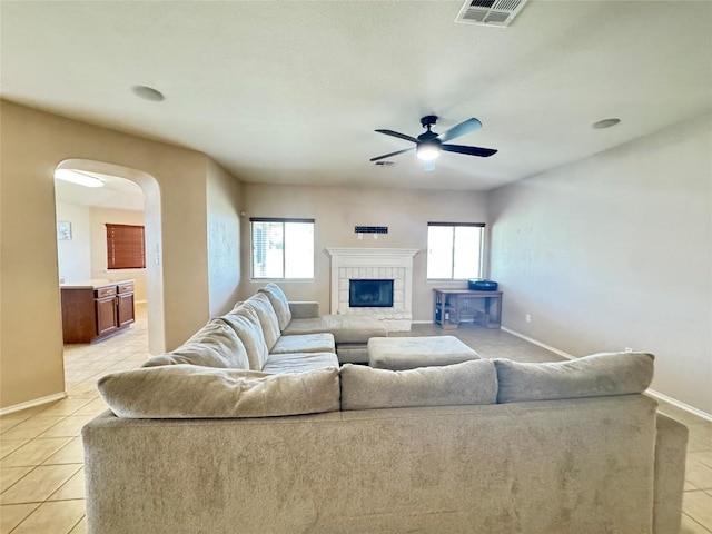 219 Memory Ln, Harker Heights, TX 76548 - living room with healthy amount of natural light, light tile patterned floors, arched walkways, and a ceiling fan