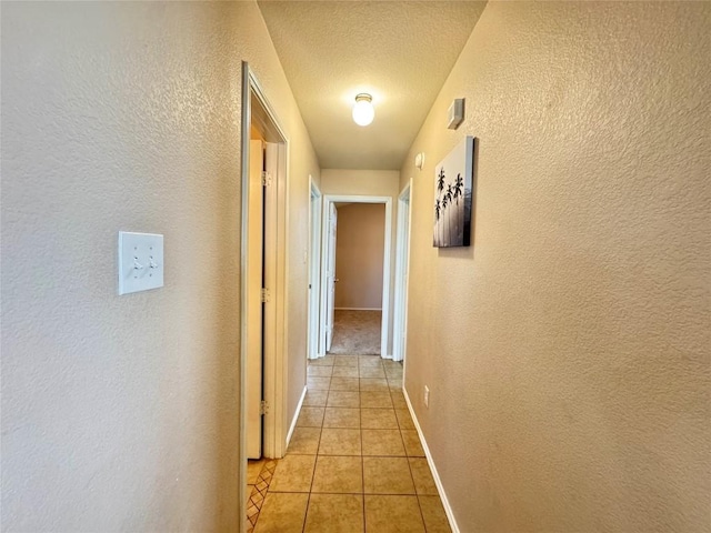 219 Memory Ln, Harker Heights, TX 76548 - hallway with a textured wall, light tile patterned floors, and a textured ceiling