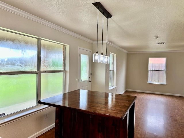3303 Solomon Dr, Killeen, TX 76542 - unfurnished dining area featuring a textured ceiling, crown molding, and wood finished floors