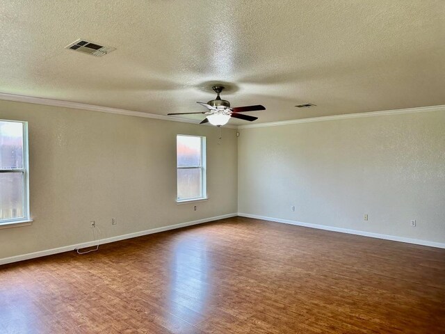 3303 Solomon Dr, Killeen, TX 76542 - empty room featuring dark wood-style flooring, a textured ceiling, a ceiling fan, and crown molding