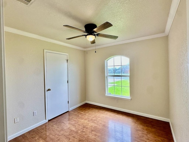 3303 Solomon Dr, Killeen, TX 76542 - spare room featuring wood finished floors, a textured ceiling, a ceiling fan, ornamental molding, and a textured wall