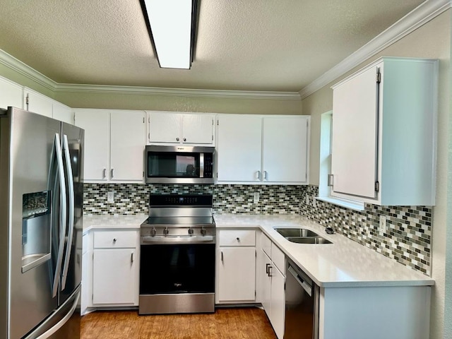 3303 Solomon Dr, Killeen, TX 76542 - kitchen with appliances with stainless steel finishes, ornamental molding, light countertops, light wood finished floors, and backsplash