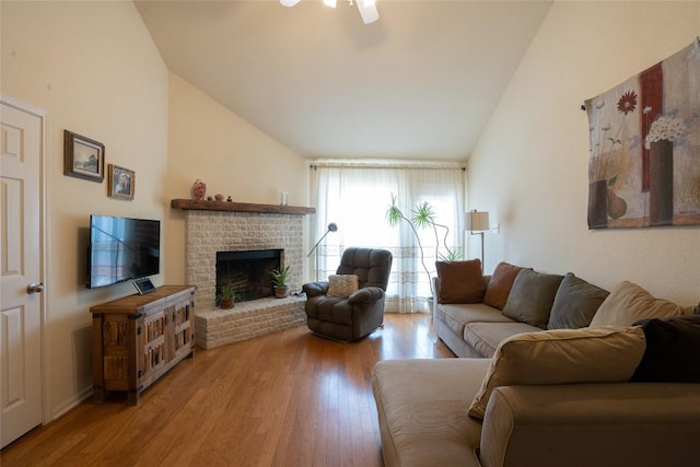 194 Rabbit Trl, Dale, TX 78616 - living room with wood finished floors, a brick fireplace, a ceiling fan, and high vaulted ceiling