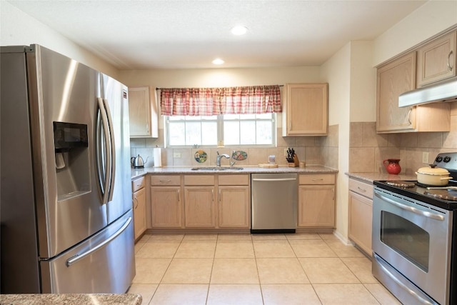 194 Rabbit Trl, Dale, TX 78616 - kitchen with appliances with stainless steel finishes, light brown cabinets, under cabinet range hood, backsplash, and recessed lighting
