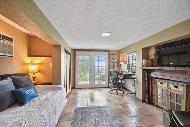 21013 Fawn Ridge Dr, Lago Vista, TX 78645 - tiled bedroom featuring access to exterior, a desk, french doors, a textured wall, and a textured ceiling