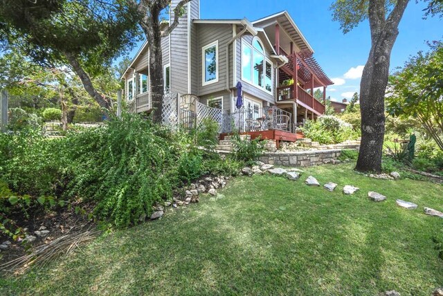 21013 Fawn Ridge Dr, Lago Vista, TX 78645 - view of property exterior featuring a chimney, a lawn, a balcony, and a deck