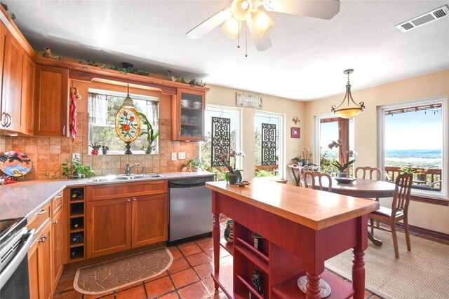 21013 Fawn Ridge Dr, Lago Vista, TX 78645 - kitchen with stainless steel appliances, plenty of natural light, butcher block countertops, and backsplash