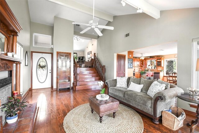 21013 Fawn Ridge Dr, Lago Vista, TX 78645 - living area featuring ceiling fan, beam ceiling, a fireplace with raised hearth, hardwood / wood-style floors, and high vaulted ceiling