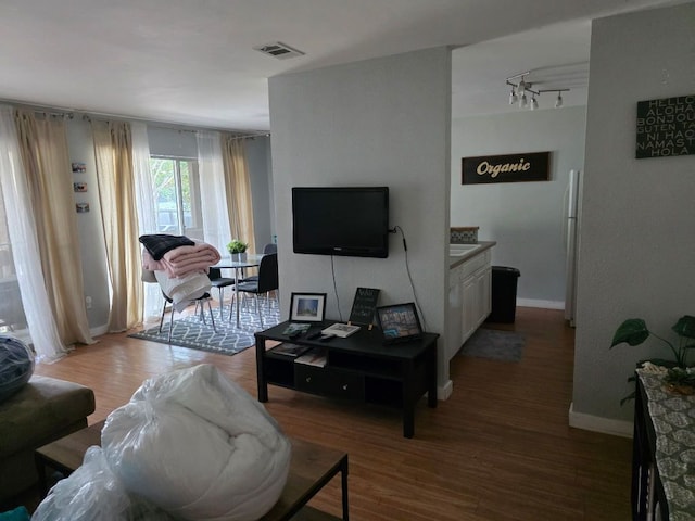 2124 Burton Dr Unit 208, Austin, TX 78741 - living room featuring wood finished floors and rail lighting