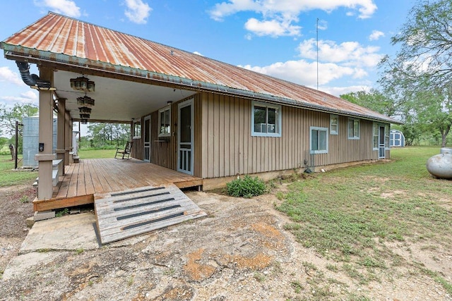 130 Anderson Ln, Red Rock, TX 78662 - view of side of property featuring a metal roof and a yard