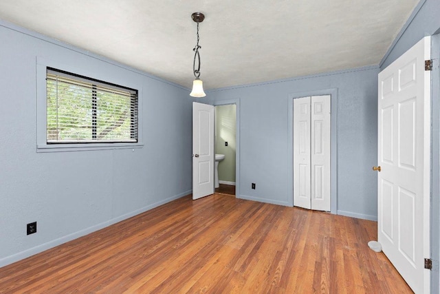 130 Anderson Ln, Red Rock, TX 78662 - unfurnished bedroom with wood finished floors and a closet