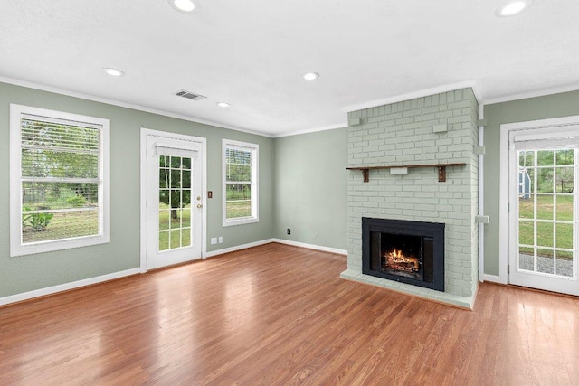 130 Anderson Ln, Red Rock, TX 78662 - unfurnished living room with ornamental molding, wood finished floors, a fireplace, and recessed lighting