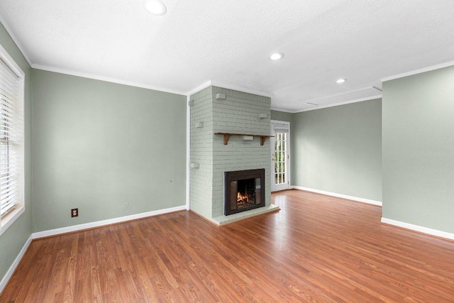 130 Anderson Ln, Red Rock, TX 78662 - unfurnished living room with wood finished floors, a fireplace, recessed lighting, and ornamental molding