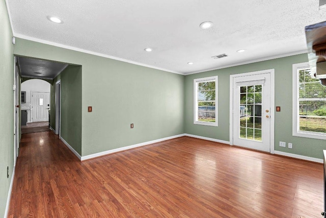 130 Anderson Ln, Red Rock, TX 78662 - unfurnished room with ornamental molding, wood finished floors, arched walkways, and recessed lighting