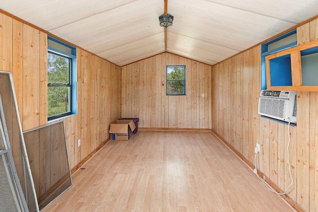 130 Anderson Ln, Red Rock, TX 78662 - spare room with plenty of natural light, wood finished floors, lofted ceiling, wood walls, and cooling unit