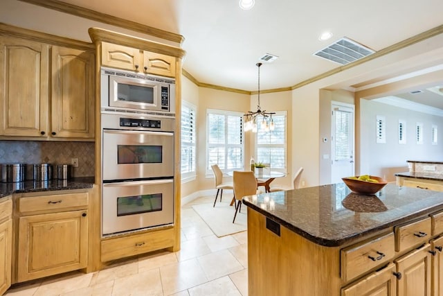 5120 Mansfield View Ct, Austin, TX 78732 - kitchen featuring appliances with stainless steel finishes, a chandelier, dark stone counters, light tile patterned floors, and ornamental molding