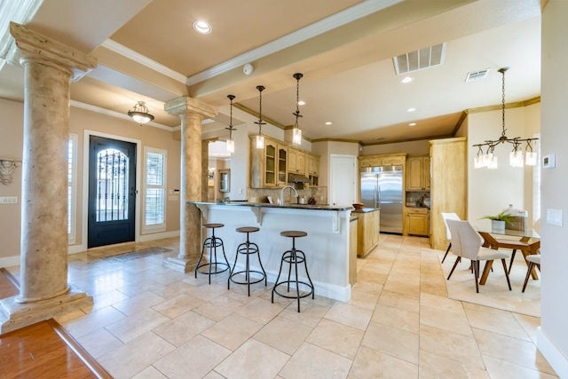 5120 Mansfield View Ct, Austin, TX 78732 - kitchen featuring decorative columns, stainless steel built in fridge, ornamental molding, a peninsula, and dark countertops