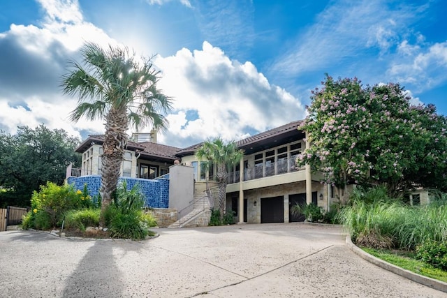 5120 Mansfield View Ct, Austin, TX 78732 - view of building exterior with concrete driveway, stairs, and a garage