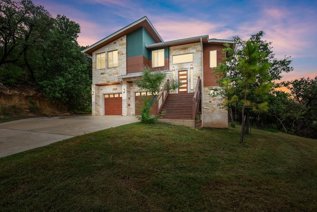 1817 High Lonesome, Leander, TX 78641 - modern home featuring stone siding, concrete driveway, a garage, and a lawn