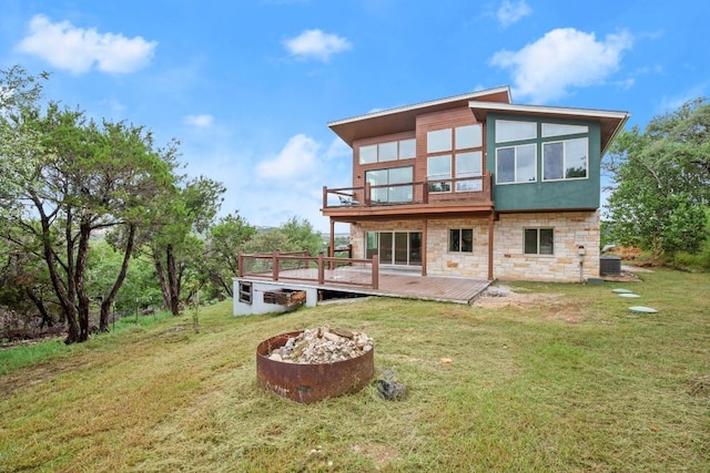 1817 High Lonesome, Leander, TX 78641 - rear view of property with an outdoor fire pit, stone siding, a yard, and a wooden deck