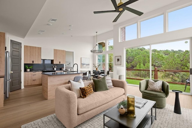1817 High Lonesome, Leander, TX 78641 - living room featuring a high ceiling, light wood finished floors, and ceiling fan