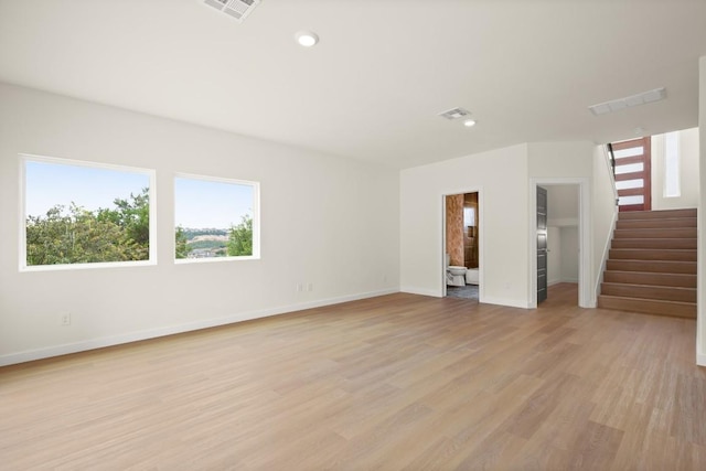 1817 High Lonesome, Leander, TX 78641 - unfurnished living room featuring stairs, light wood-type flooring, and recessed lighting